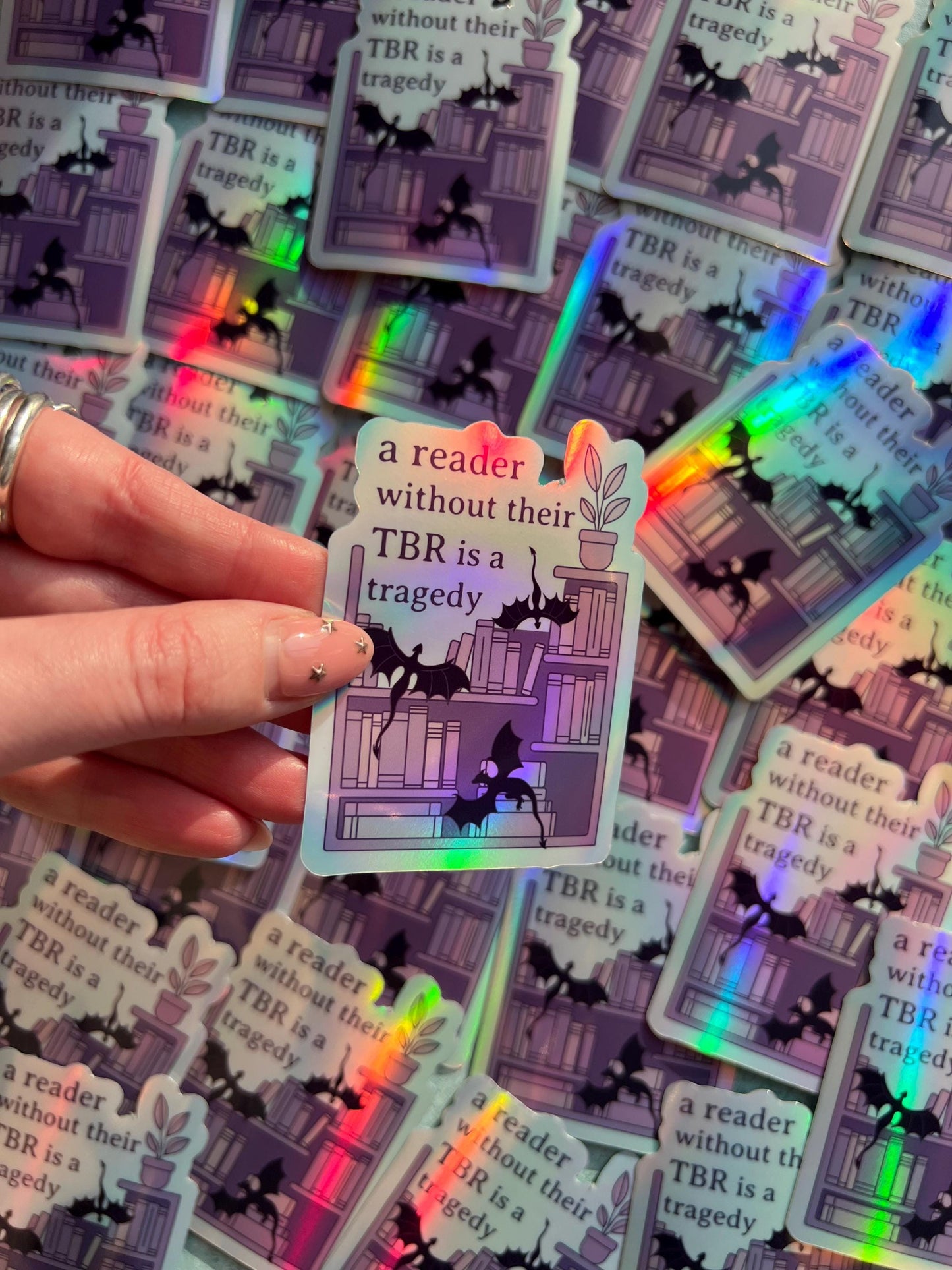A reader without a TBR is a tragedy holographic sticker - fantasy romance reader sticker