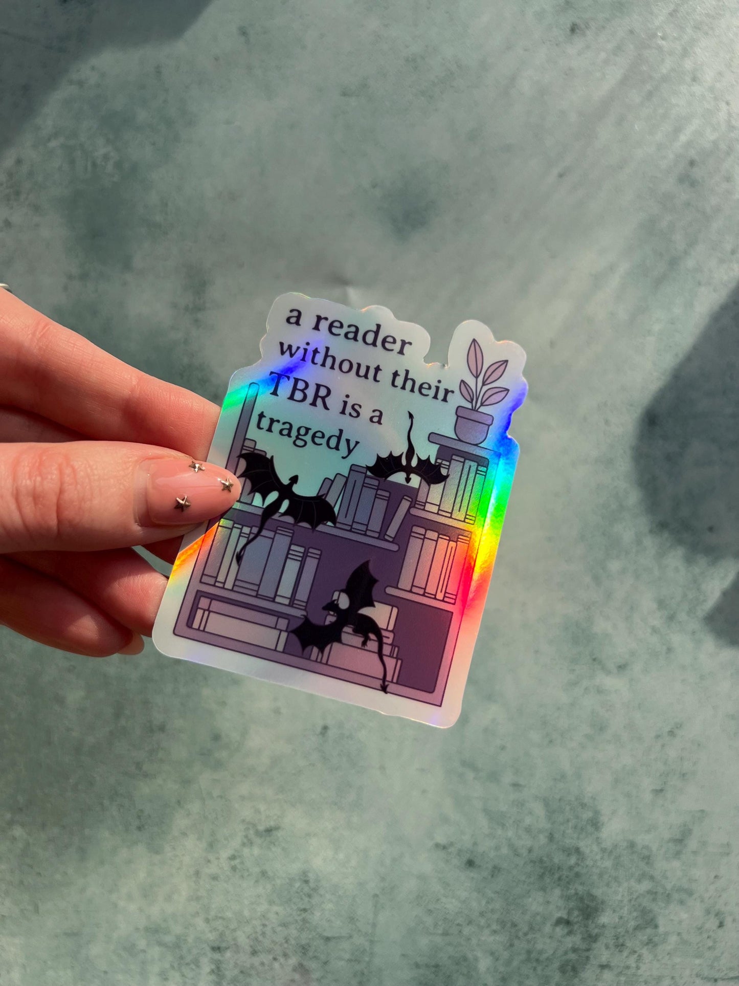 A reader without a TBR is a tragedy holographic sticker - fantasy romance reader sticker