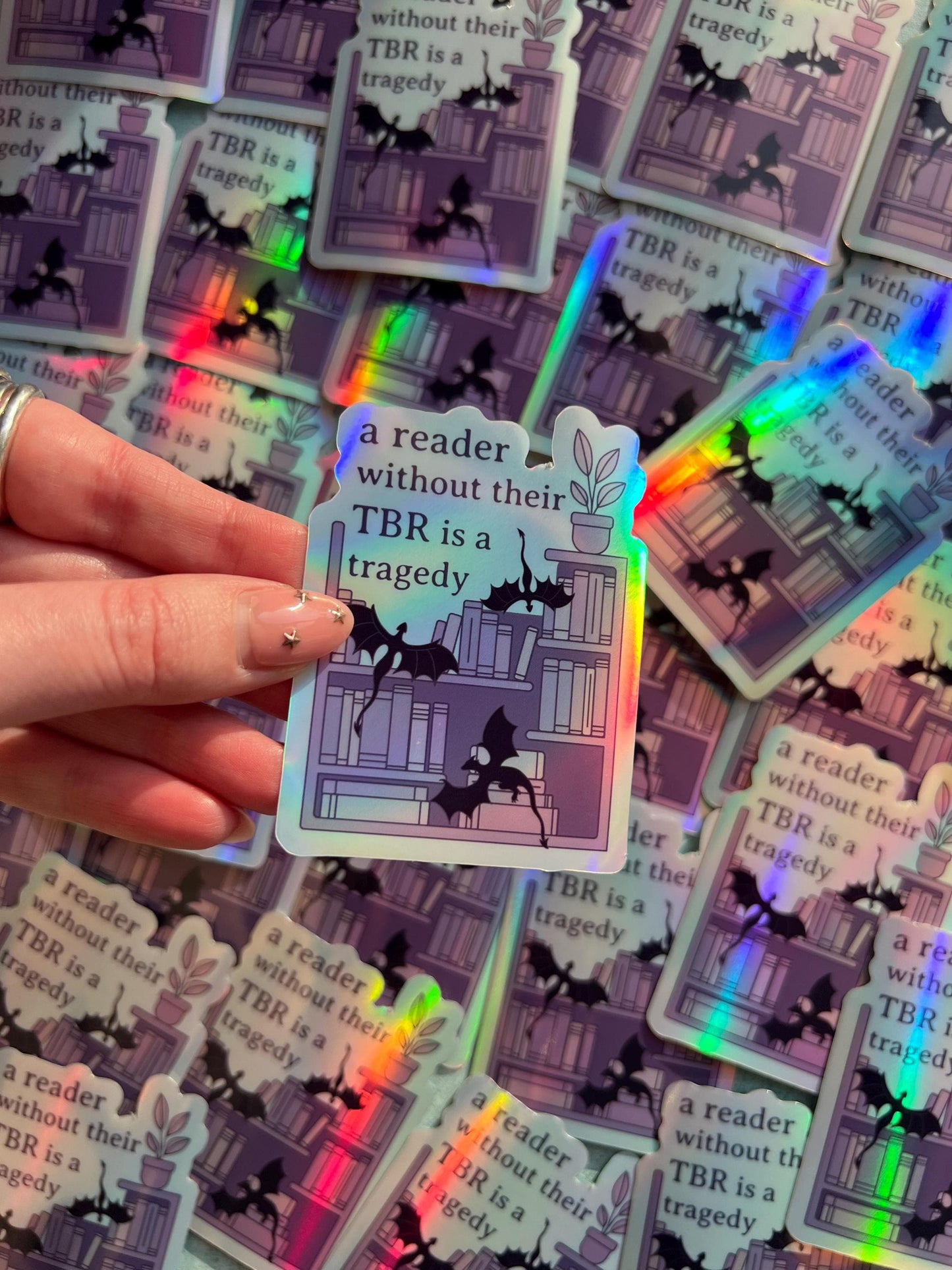 A reader without a TBR is a tragedy holographic sticker - fantasy romance reader sticker