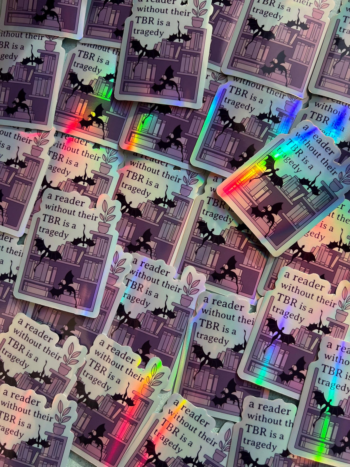 A reader without a TBR is a tragedy holographic sticker - fantasy romance reader sticker